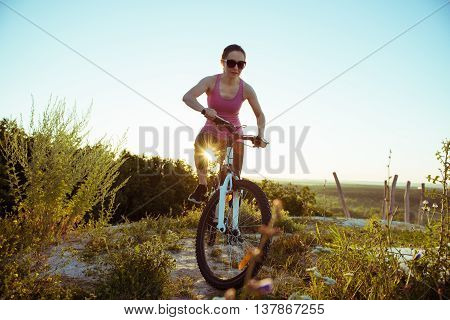 a beautiful young woman rides a bike on the nature day
