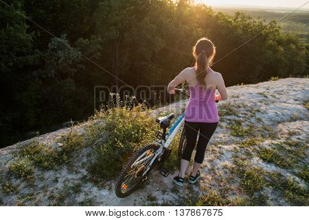 a beautiful young woman rides a bike on the nature day