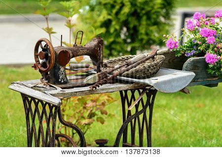 Old sewing machine used in floral arrangement in park of attraction in Zator, Poland. 8 JULY 2016, ZATOR. POLAND.
