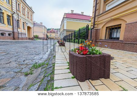 Stone bed with flowers on a city street. Architecture