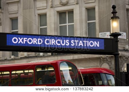 LONDON, UNITED KINGDOM - SEPTEMBER 11 2015: Oxfor Circus Station underground board in London with two traditional red buses in the background