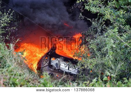 TULCEA, ROMANIA - JUNE 11: Danube Delta Rally special trial windfarm on June 11, 2016 in Tulcea, Romania; car on fire 
