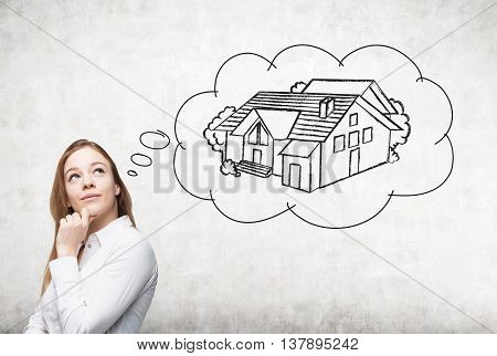 Attractive european businesswoman thinking about real estate on concrete background. Mortgage concept
