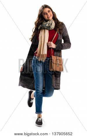 Woman in sweater coat. Brown handbag and blue jeans. Autumn outfit with stylish scarf. New outerwear and accessories.