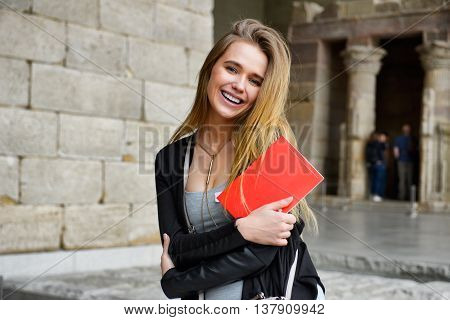 Happy tourist girl sightseeing city with map and guide book