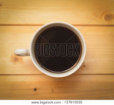 cup of coffee on a wooden table close