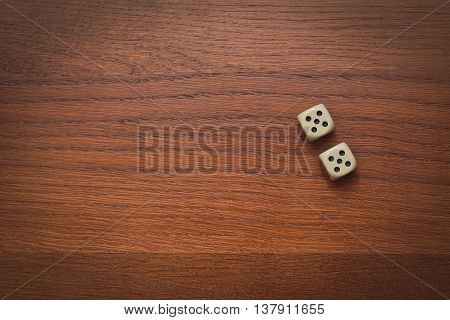 two dice number double 5 on the wooden table