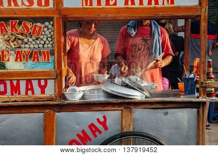 UBUD, INDONESIA - MARCH 08: Vendors cook meatball soup at the street stall in Ubud Bali Indonesia on March 08 2016