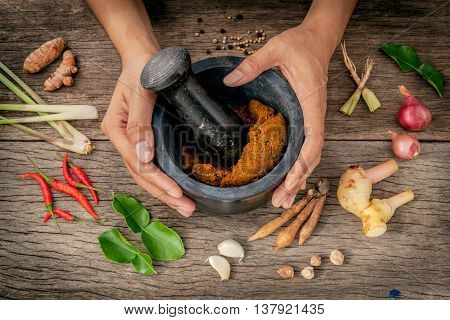 The Women Hold Pestle With Mortar And Spice Red Curry Paste Ingredient Of Thai Popular Food On Rusti