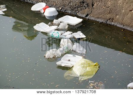 Garbage in the water / waste and garbage mismanagement concept