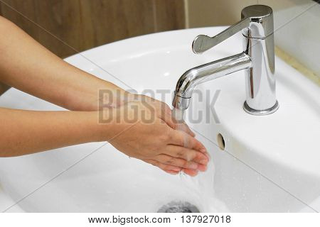 Female hands washing for cleaness in the bathroom