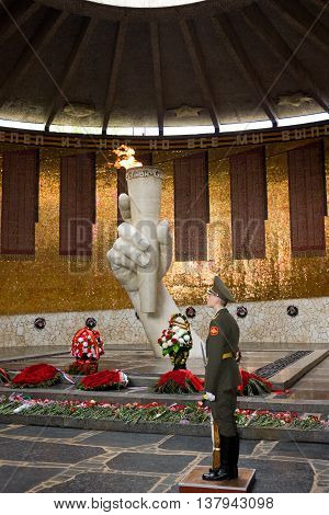 VOLGOGRAD, RUSSIA - MAY 8, 2011: War memorial Eternal flame on Mamayev Hill dedicated to heroes of Stalingrad battle . The statue are by Soviet sculptor Yevgeny Vuchetich.