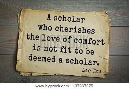 Ancient chinese philosopher Lao Tzu quote on old paper background.  A scholar who cherishes the love of comfort is not fit to be deemed a scholar. 
