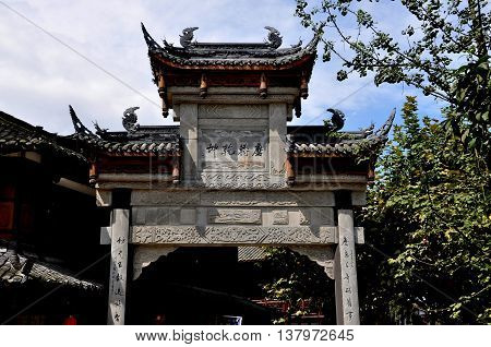 Jie Zi Ancient Town China - October 1 2010: One of several grand ceremonial gates with flying eave roofs and dragon figures that grace the ancient town streets