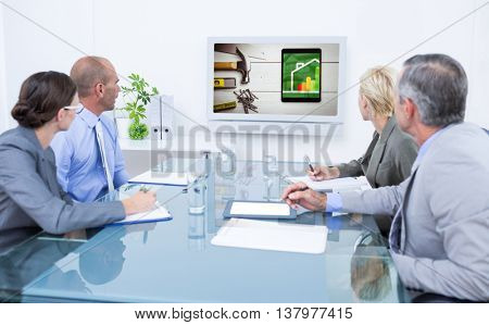 Business team looking at time clock against energy efficient house graphic against a background