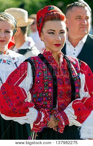 ROMANIA TIMISOARA - JULY 7 2016: Young woman from Romania in traditional costume present at the international folk festival "International Festival of hearts" organized by the City Hall Timisoara.