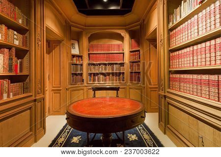 Brussels, Belgium - Apr 2: Many Bookshelves With Old Volumes Of Books And Antique Round Table Inside