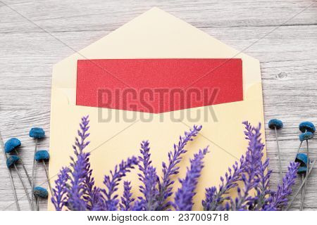 Red Greeting Card In Envelope And Flowers On A Light Wooden Background
