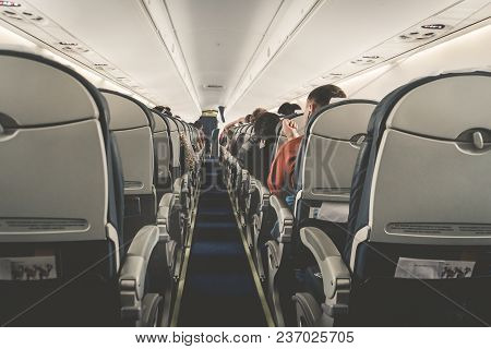 Interior Of Airplane With Passengers On Seats Waiting To Taik Off. Horizontal Composition. Boring Fl