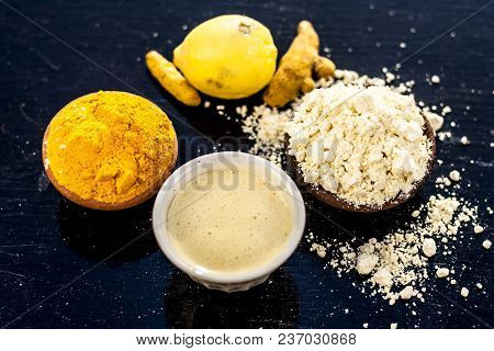 Chana,haldi,limbo Ka Ubtan Or Ayurvedic Face Pack Of Turmeric, Lemon, And Gram Flour On Wooden Surfa