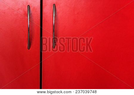 Close Up Handles On Red Door Of Wooden Cabinet