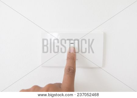 Closeup Hand Turn Off A Power Button,finger Press Light Button,hand With Power Plug,interior Electri