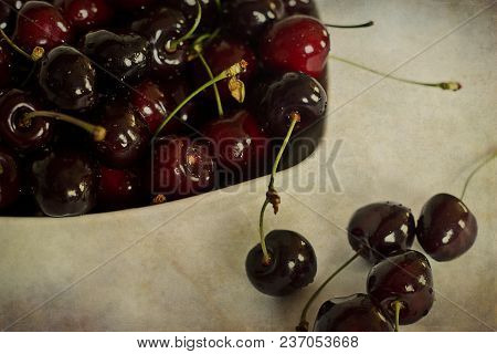 Beautiful Juicy Fresh Summer Cherries In A White Bowl On A Vintege Background