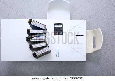 Binders With Papers Are Waiting To Be Processed With Bookkeeper. Internal Revenue Service Inspector 