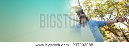 Low angle of man in virtual reality headset embracing forest and green transition