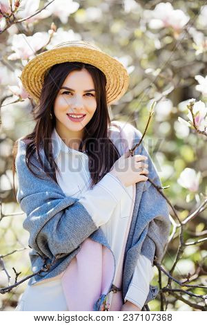 Happy Outside. Pensive Beautiful Girl In Straw Hat Looking Up Smiling Holding Touching Hat Isolated