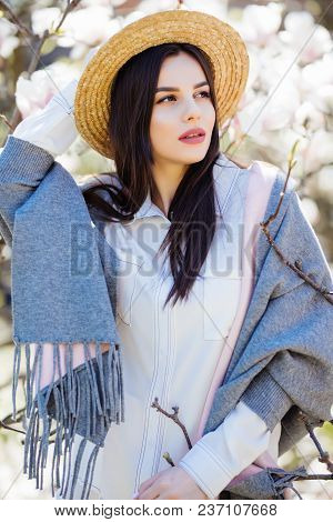 Happy Outside. Pensive Beautiful Girl In Straw Hat Looking Up Smiling Holding Touching Hat Isolated