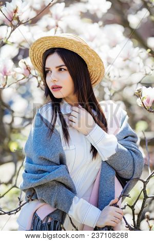 Happy Outside. Pensive Beautiful Girl In Straw Hat Looking Up Smiling Holding Touching Hat Isolated