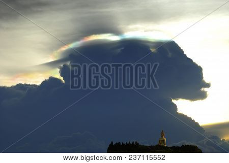 Cloud Iridescence, Rainbow Irisation Against Golden Big Buddha Statue On Mountain Top In Thailand