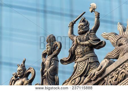 Decoration Sculpture On Daci Buddhist Temple Roof Against Modern Building In Chengdu, China