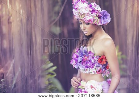 Young Asian Woman Tanned Skin And Black Shine Long Hair With Flowers Costume Design. Fancy Fairy Nym