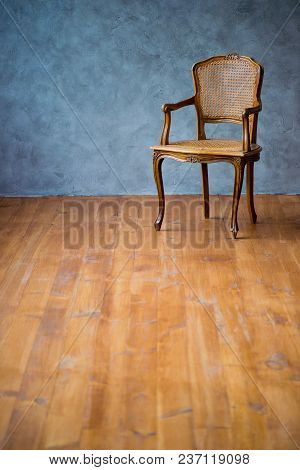 Old Chair On A Gray Wall Background