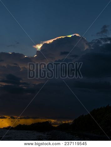 Cloud Iridescence, Rainbow Irisation Over Golden Sea Coast Line.