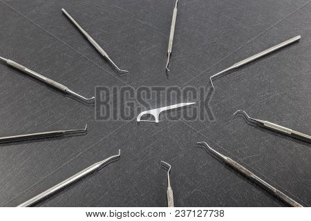 Oral Device : White Dental Flosser On Gray Background.