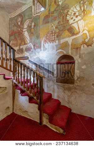 Cairo, Egypt - March 24 2018: Wall With Coptic Fresco Paintings And Staircase Leading To The Church 