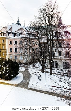 Colored Houses In Warsaw Old Town After Snow Storm In Winter, Colorful Exteriors Against The White S