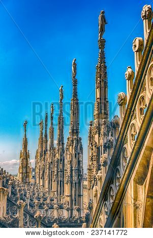 Detail With Marble Spiers And Statues On The Roof Of The Gothic Cathedral Of Milan, Italy