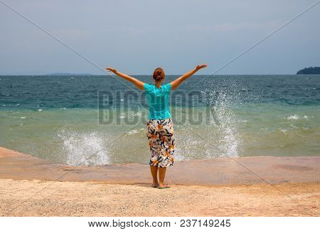 Young Woman And Sea Wave. Sunny Tropical Coast View With Relaxed Woman. Red Hair Woman On Beach. Pla
