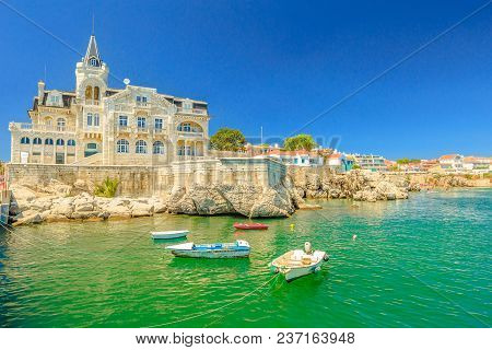 Scenic Landscape Of Abandoned Palace Seixas And Boats On The Waterfront Of Cascais, Lisbon Coast In 