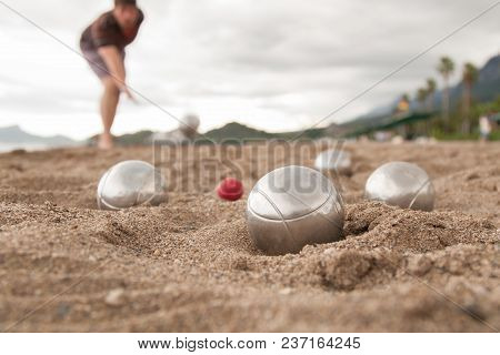Beach. A Game Of Bocha. Brilliant Silver Balls For A Bocha On The Sand.
