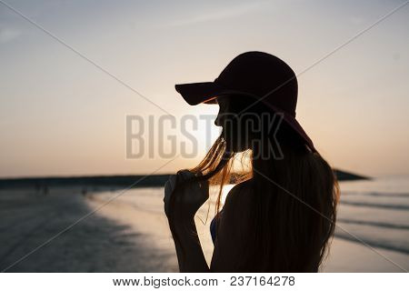 Beautiful Girl On A Sunset Background On A Sandy Beach. Woman.
