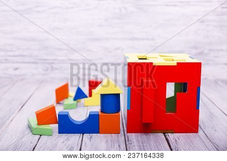 Educational Games For Children. Red, Yellow, Pink, Blue Geometrical Figures On The Wooden Background