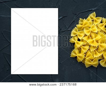 Farfalle Raw Farfallini Background With Pasta On A Black Background With A Side. A View From The Top