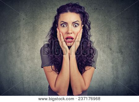 Amazed Shocked Woman Looking At Camera On Gray Wall Background