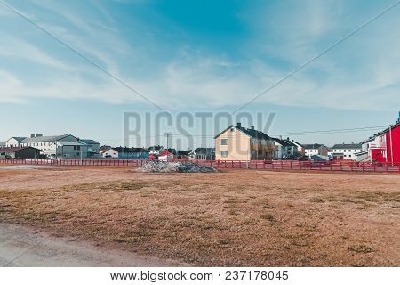 Norway Vardo, Houses In A Neighborhood On A Summer Day With Some Snow Still Left