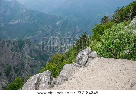 A Small Village Is At The Bottom Of A Deep Canyon